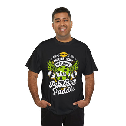“Male model wearing Teezoca Never Underestimate an Old Man with a Pickleball Paddle shirt, funny vintage pickleball graphic tee, black unisex front.”

