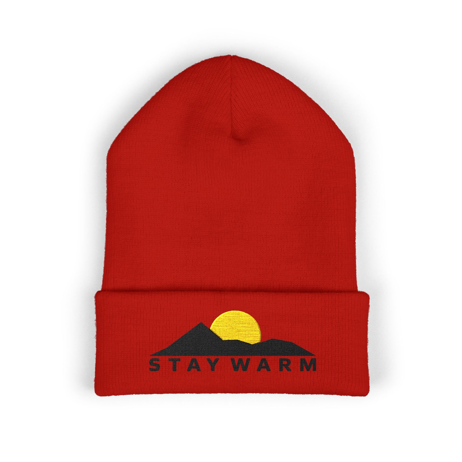 Red beanie with mountain and sun design and 'Stay Warm' text on a white background