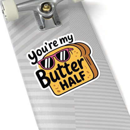 Sticker on a skateboard deck with bread design and text 'You're my Butter HALF'. TEEZOCA