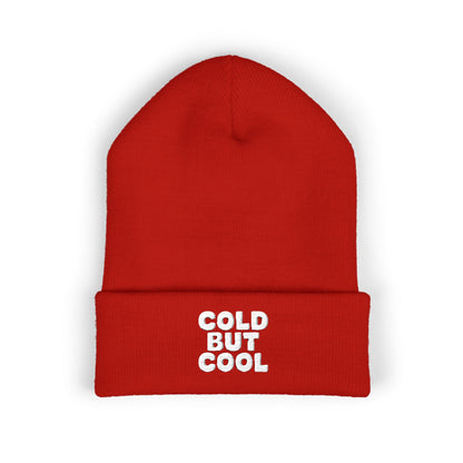 Red beanie with 'Cold But Cool' embroidery text on a white background