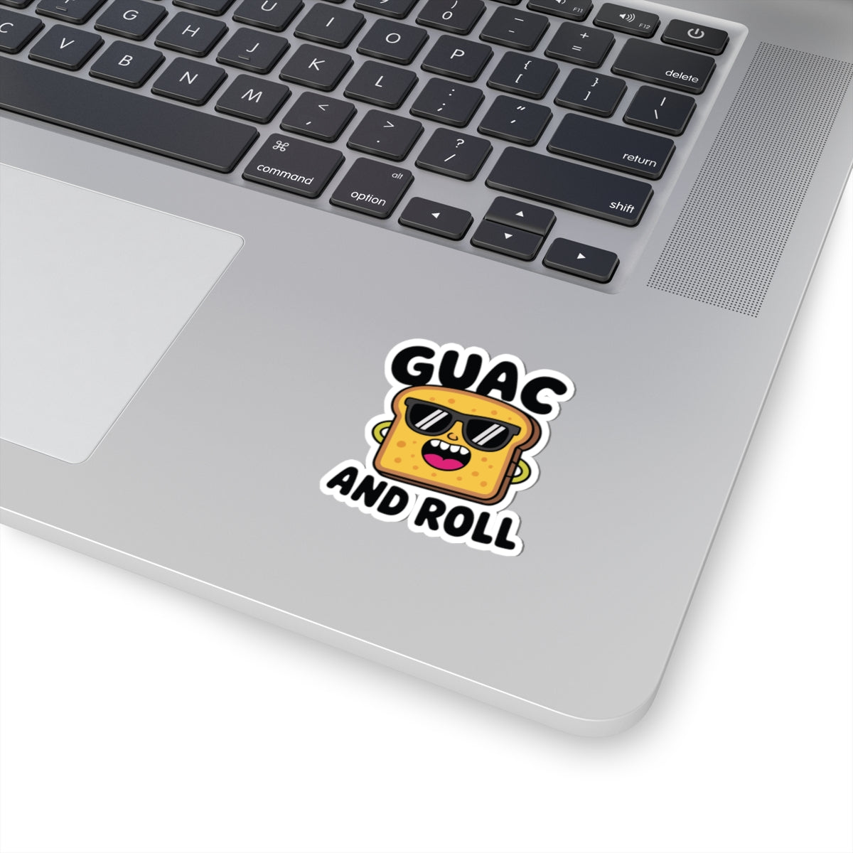 Laptop with a sticker that says 'GUAC AND ROLL' on the palm rest area. TEEZOCA