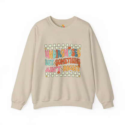 Beige sweatshirt with colorful text design on a white background