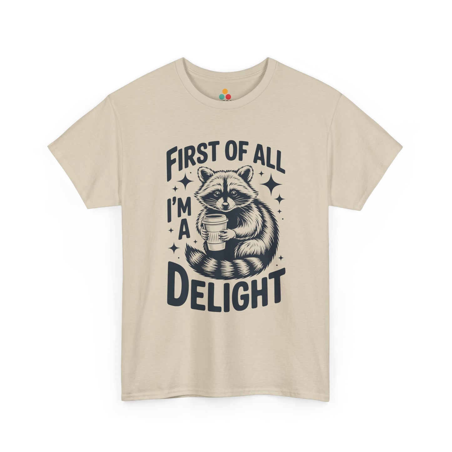 TEEZOCA beige “First Of All I’m A Delight” raccoon coffee tee displayed flat.