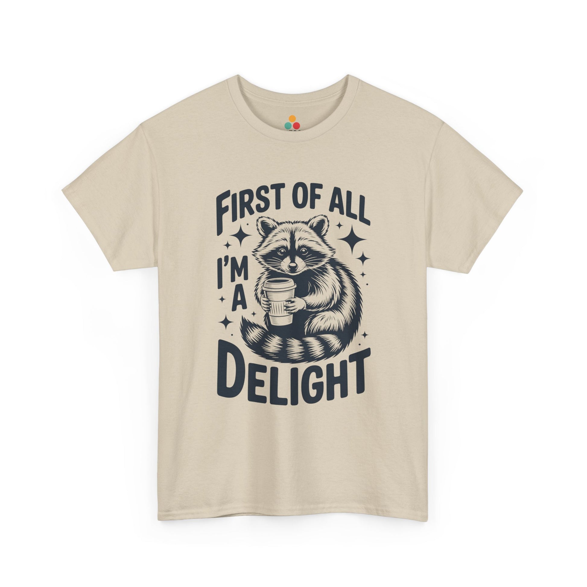 TEEZOCA beige “First Of All I’m A Delight” raccoon coffee tee displayed flat.