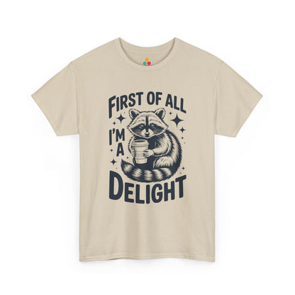 TEEZOCA beige “First Of All I’m A Delight” raccoon coffee tee displayed flat.