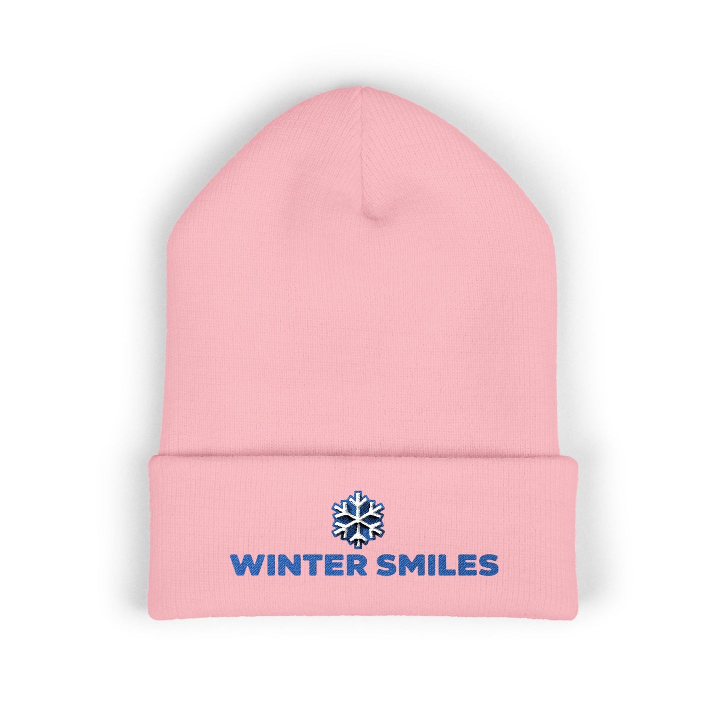 Pink beanie with 'Winter Smiles' logo on a white background. Close-up of snowflake embroidery on cozy winter knit hat