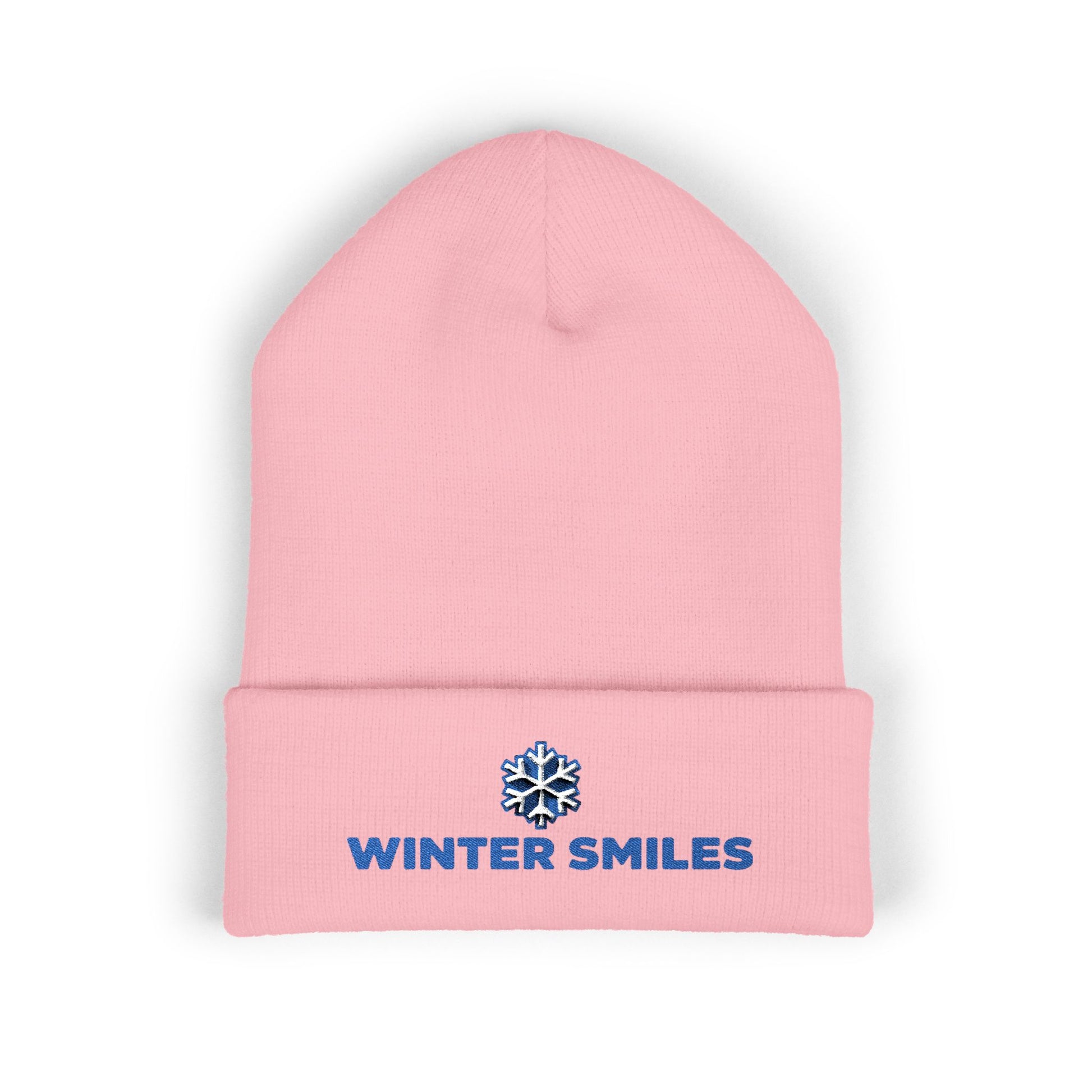 Pink beanie with 'Winter Smiles' logo on a white background. Close-up of snowflake embroidery on cozy winter knit hat