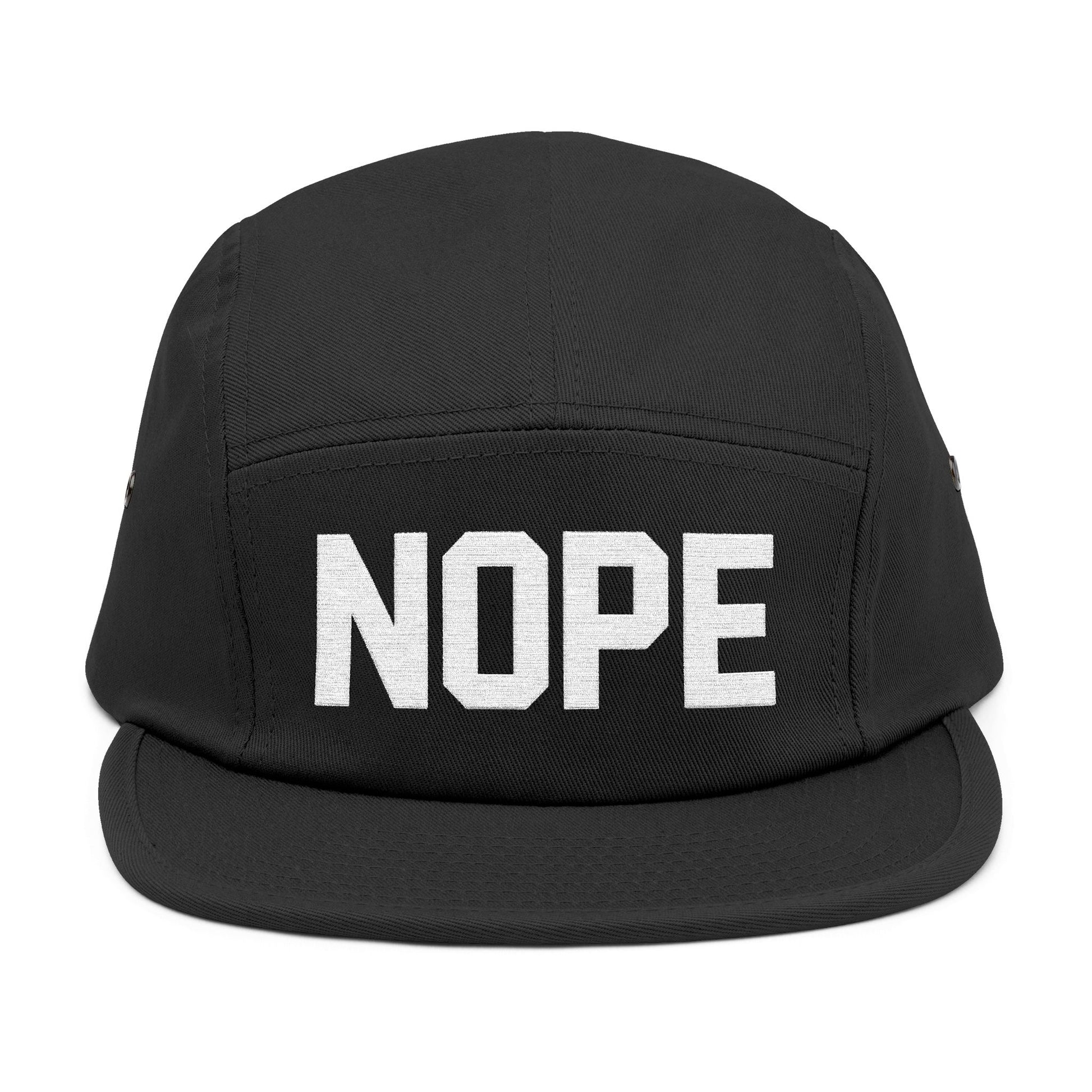 Black cap with 'NOPE' text on a white background. NOPE bold minimal typography embroidery design on cap. TEEZOCA