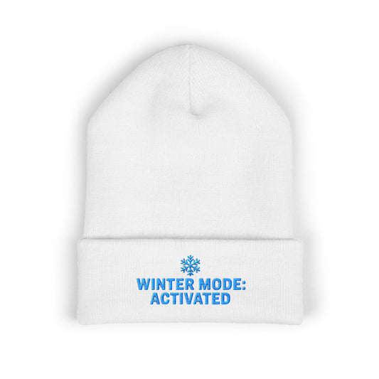 White beanie with blue text 'Winter Mode: Activated' on a white background. Winter Mode Activated embroidered snowflake beanie in soft acrylic knit