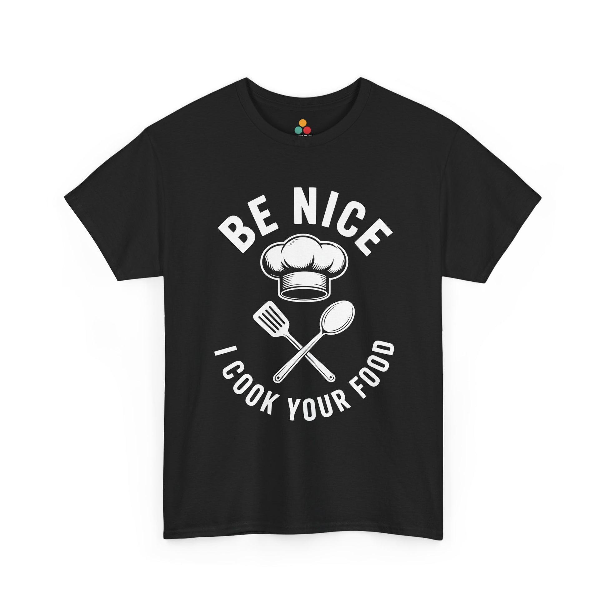 “Teezoca Be Nice I Cook Your Food shirt, chef hat above crossed spatula and spoon with bold white text, black tee, front view.”

