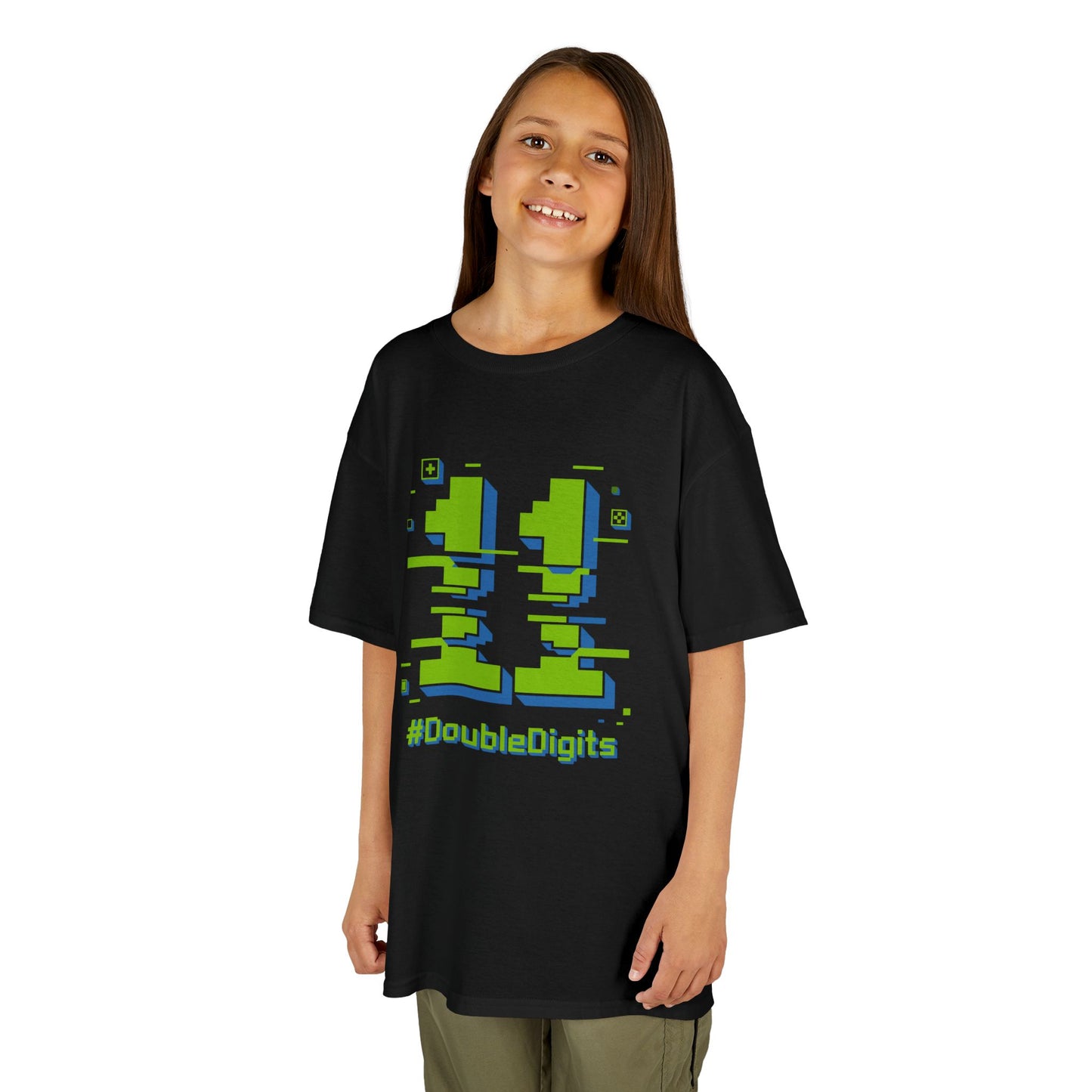 Child wearing a black t-shirt with green and blue graphics and text on a white background  Black kids’ t‑shirt with neon green and blue pixel number 11 and “#DoubleDigits” gamer text, flat front view.