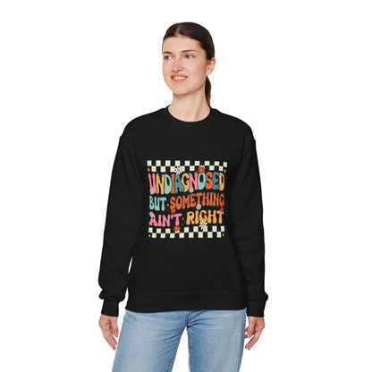 Person wearing a black sweatshirt with colorful text design on a white background