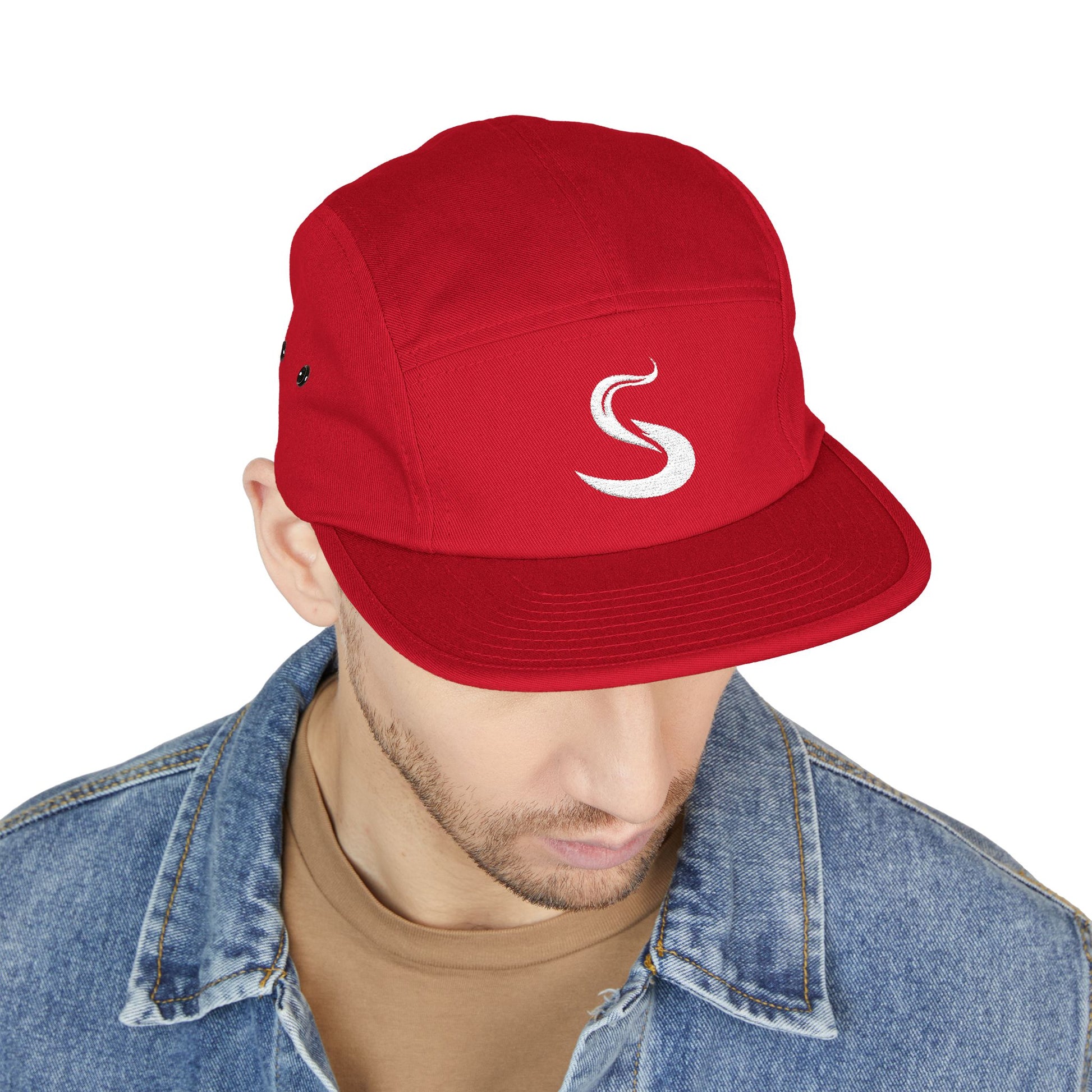 Red cap with a white logo worn by a person on a white background. Minimalist S-shaped steam swirl embroidery design in bold white stitched on a 5-panel cap by TEEZOCA