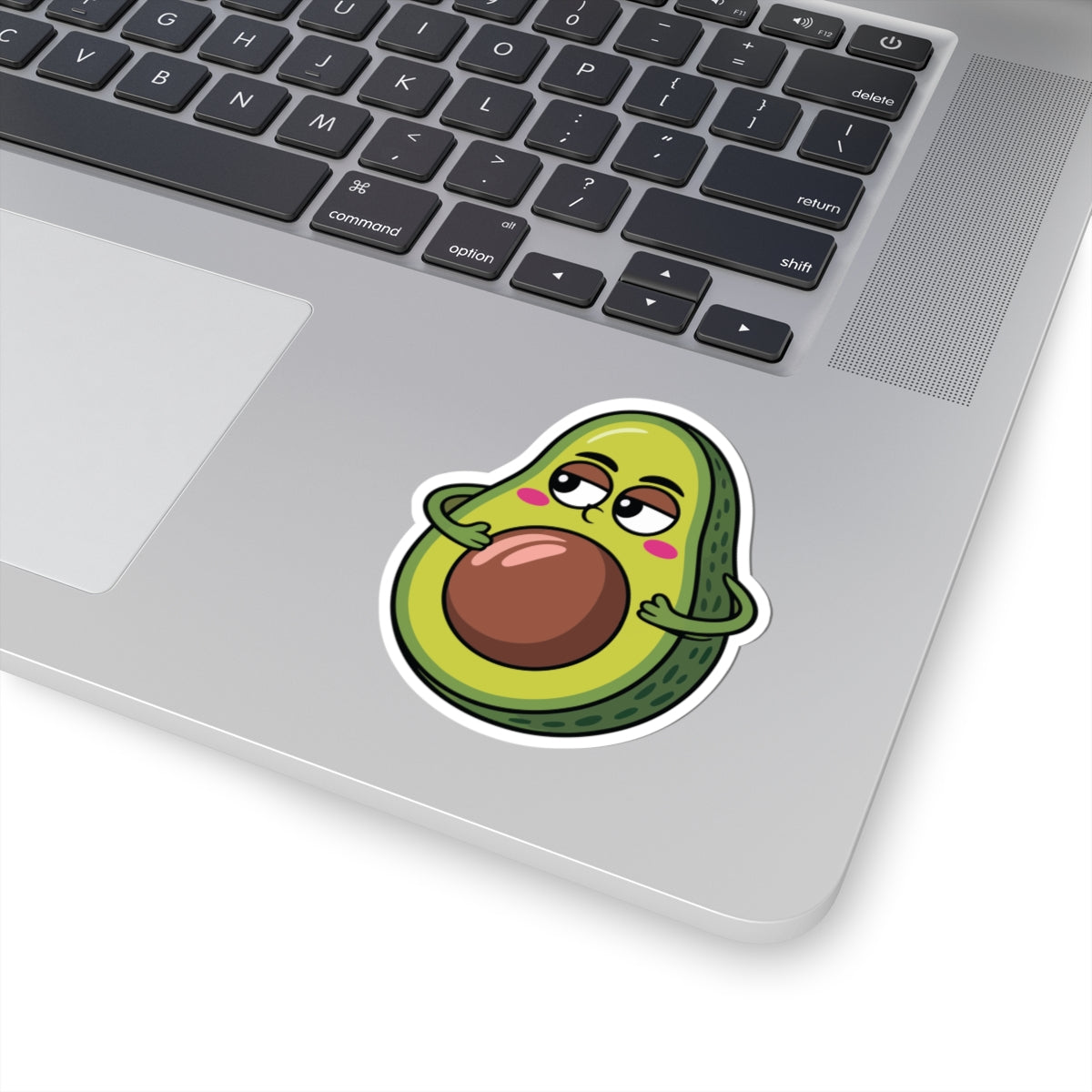 Laptop with a cartoon avocado sticker on the palm rest area. TEEZOCA