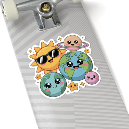Skateboard with cartoon stickers of a sun, Earth, and other planets on a gray background. TEEZOCA
