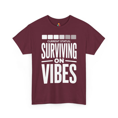 Maroon t-shirt with 'Current Status: Surviving on Vibes' text on a white background | TEEZOCA