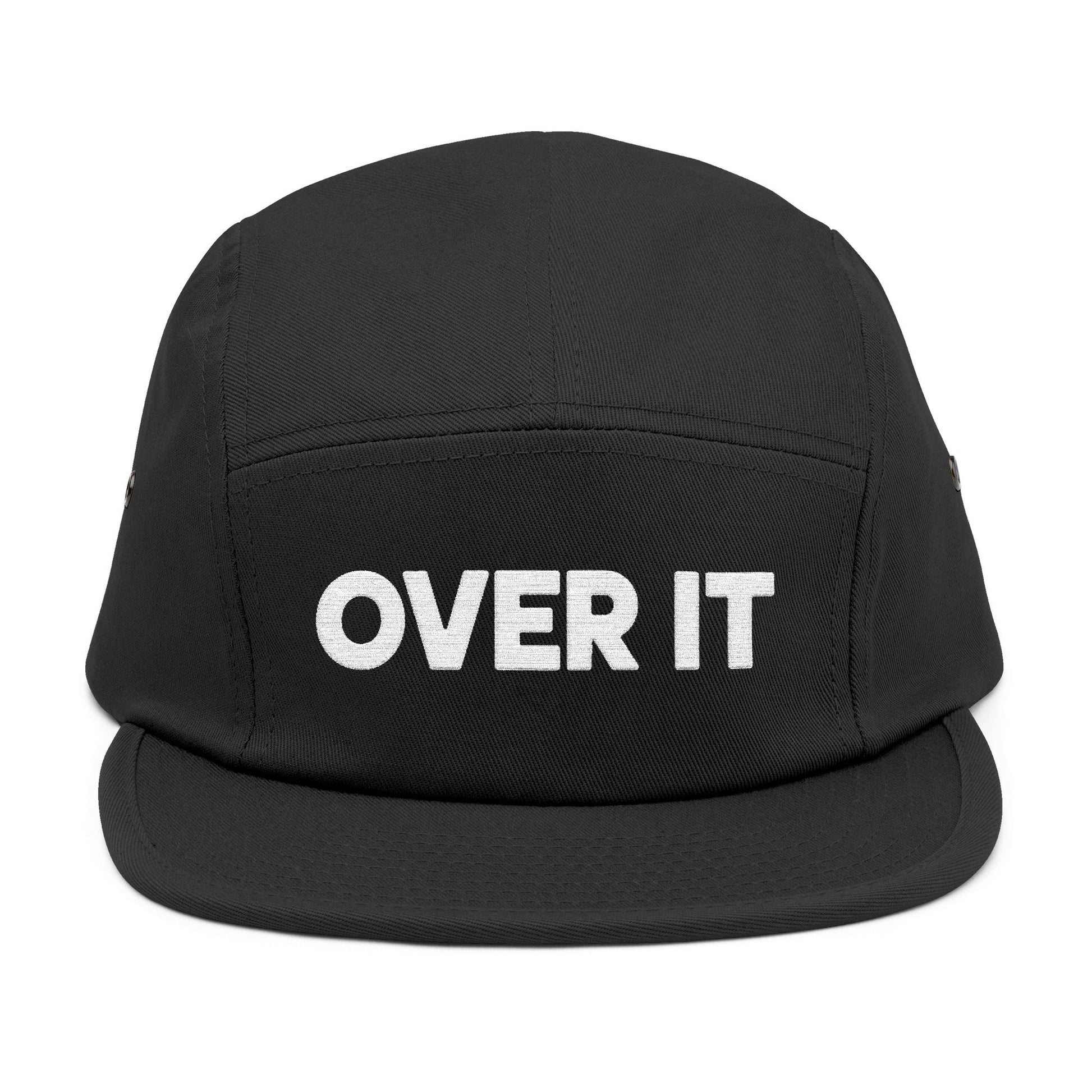 Black cap with 'OVER IT' text on a white background. OVER IT embroidered text design displayed on clean white typography. TEEZOCA