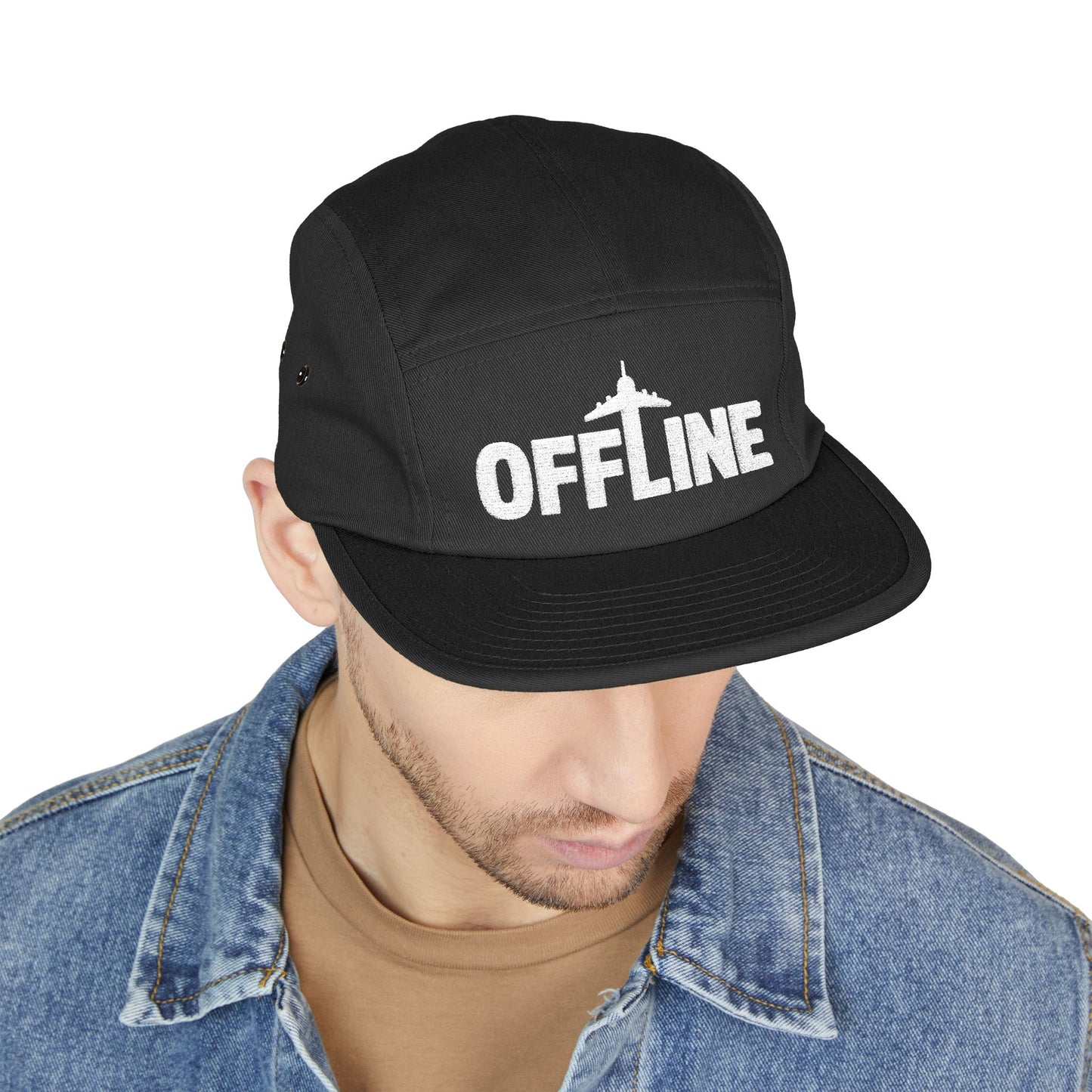 Black cap with 'OFFLINE' text worn by a person on a white background. Embroidered OFFLINE airplane graphic on black 5-panel cap. TEEZOCA