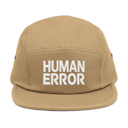 Tan cap with 'HUMAN ERROR' text on a white background. Front view of an embroidered 5-panel cap featuring the bold “HUMAN ERROR” typography in white. TEEZOCA