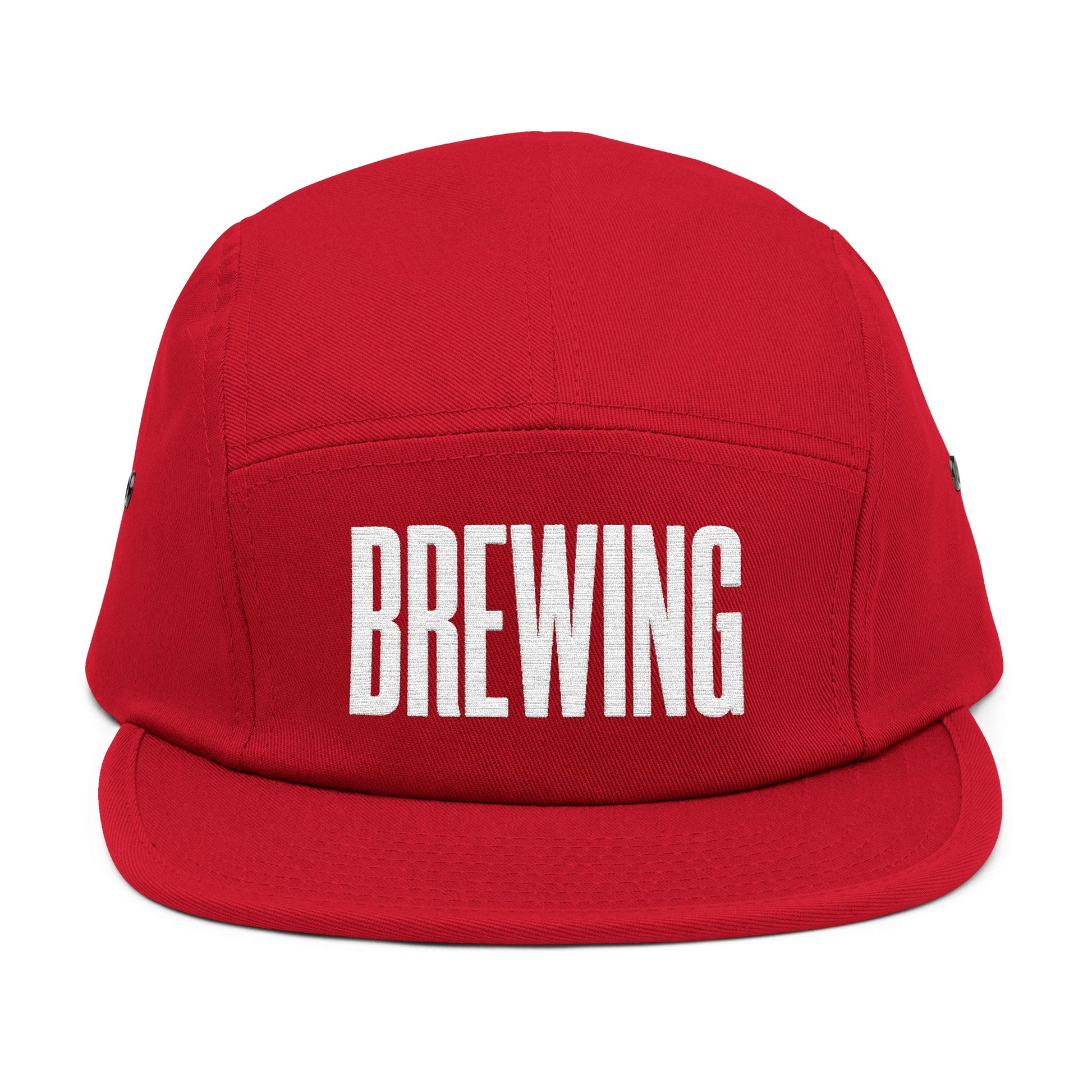 Red cap with 'BREWING' text on a white background. BREWING minimalist text embroidery design on 5-panel cap. TEEZOCA