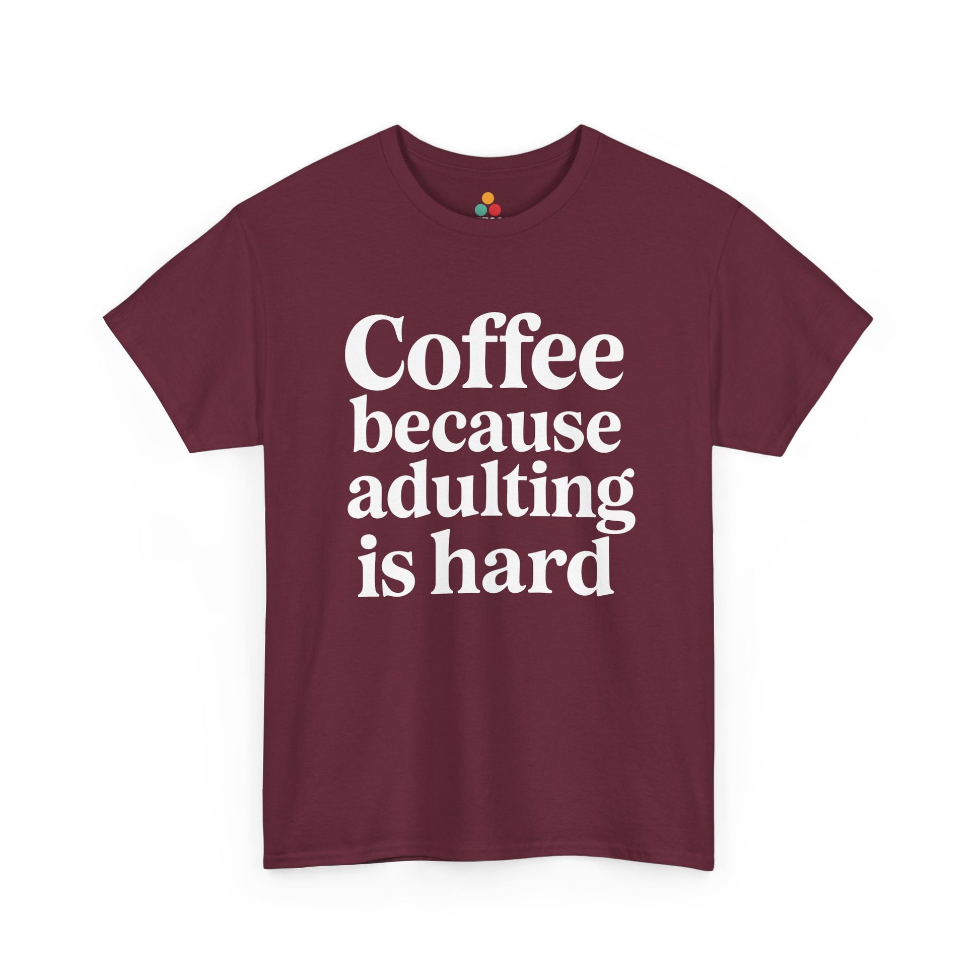 “Teezoca Coffee Because Adulting Is Hard shirt, bold white coffee quote, maroon tee, flat front display.”

