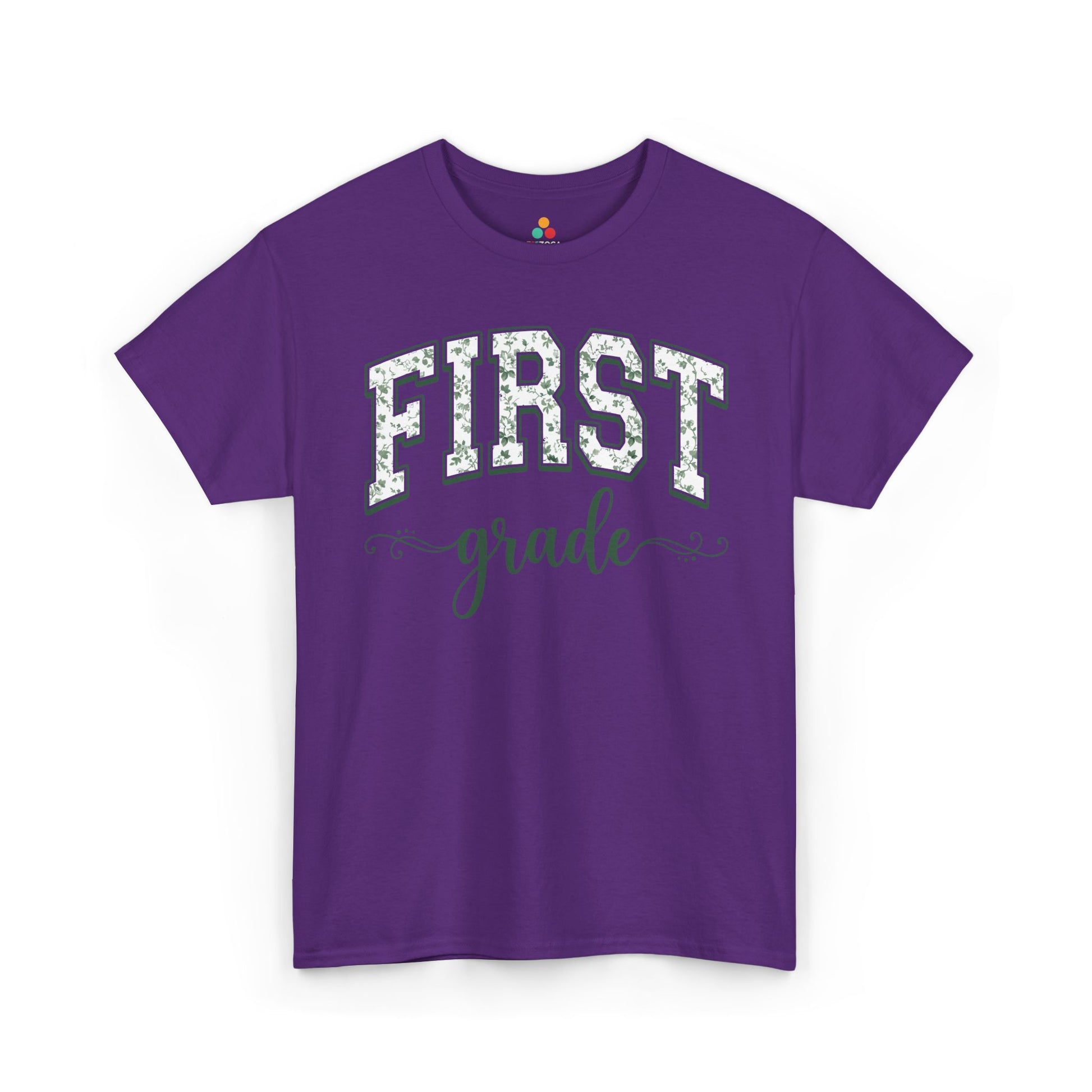 Purple t-shirt with 'FIRST grade' text on a white background. TEEZOCA floral back to school t-shirt for first grade teachers and staff, an adult tee found on Amazon and Etsy.

