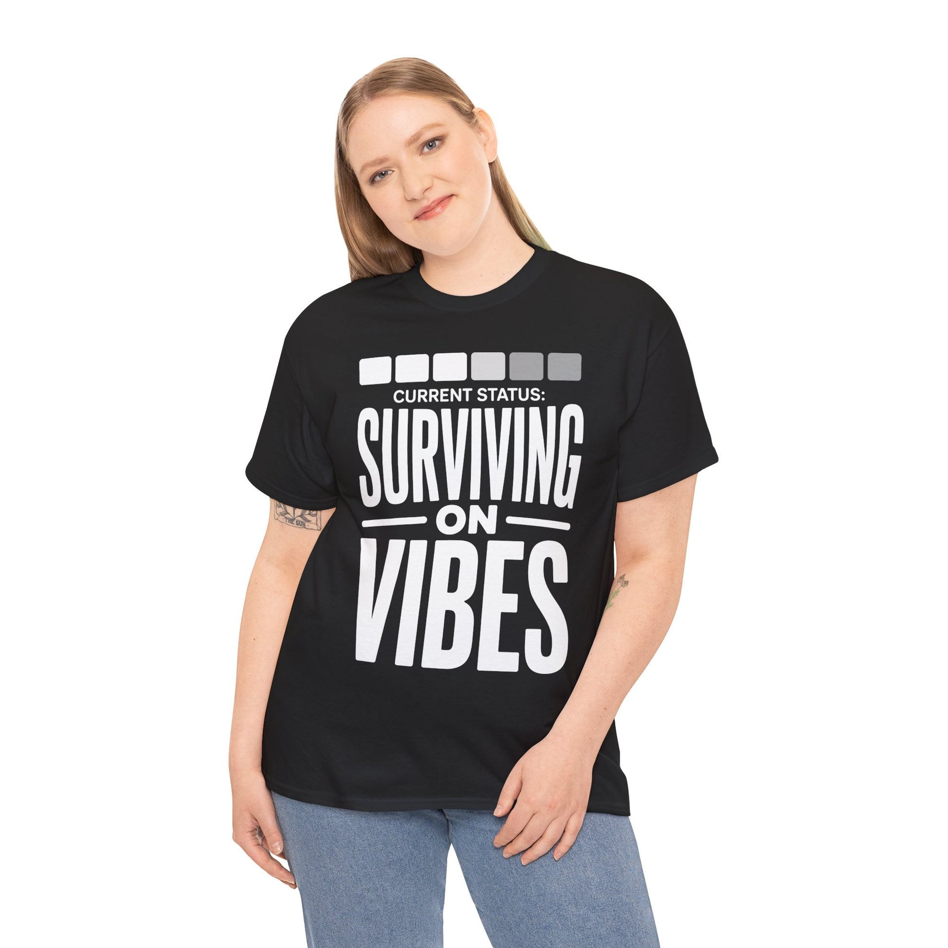 Person wearing a black t-shirt with 'Current Status: Surviving on Vibes' text | TEEZOCA