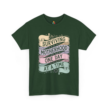 TEEZOCA forest green “Surviving Motherhood One Day At A Time” relatable mom shirt shown flat.