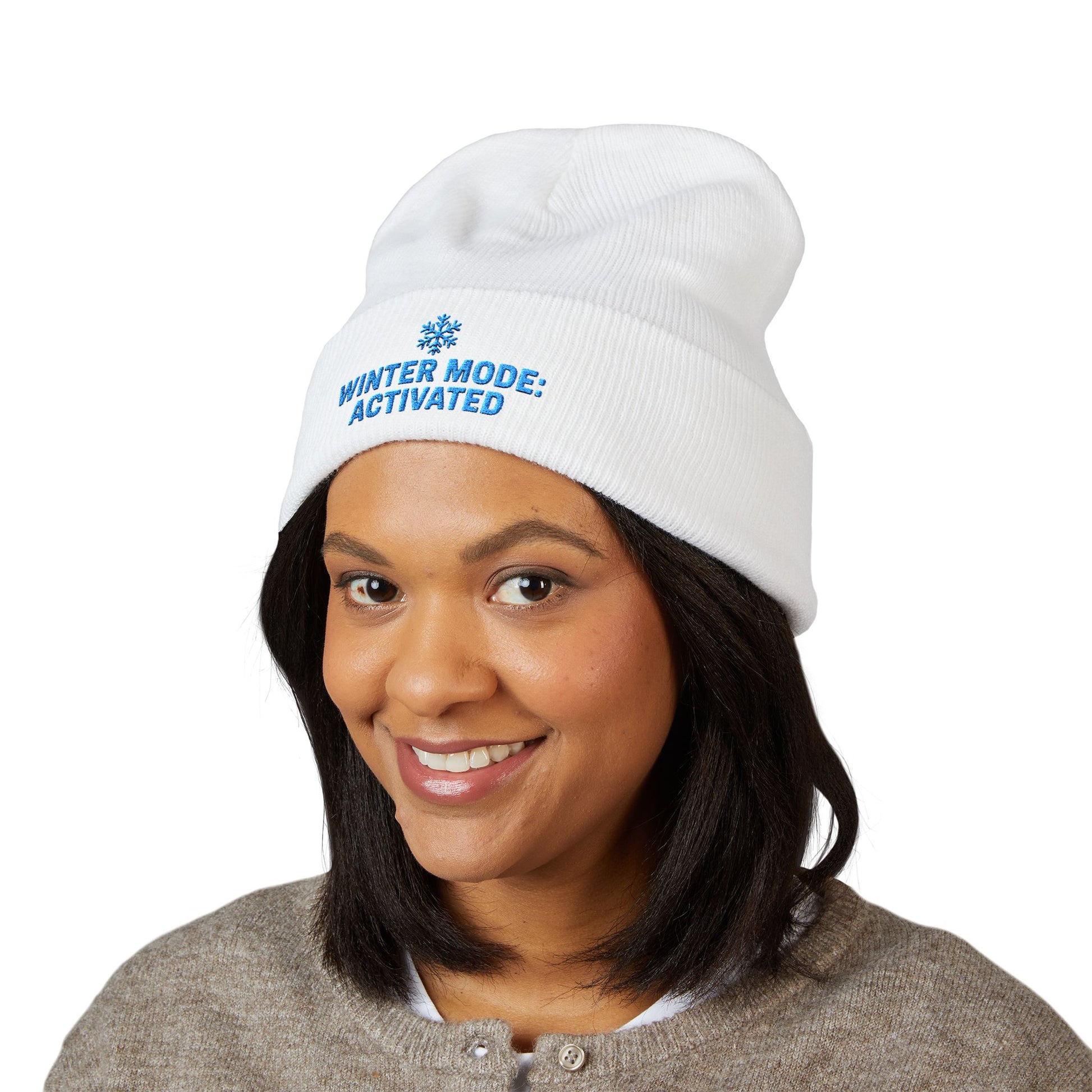 Person wearing a white beanie with 'Winter Mode: Activated' text on a white background. Winter snowflake embroidery beanie for cold-weather outfits