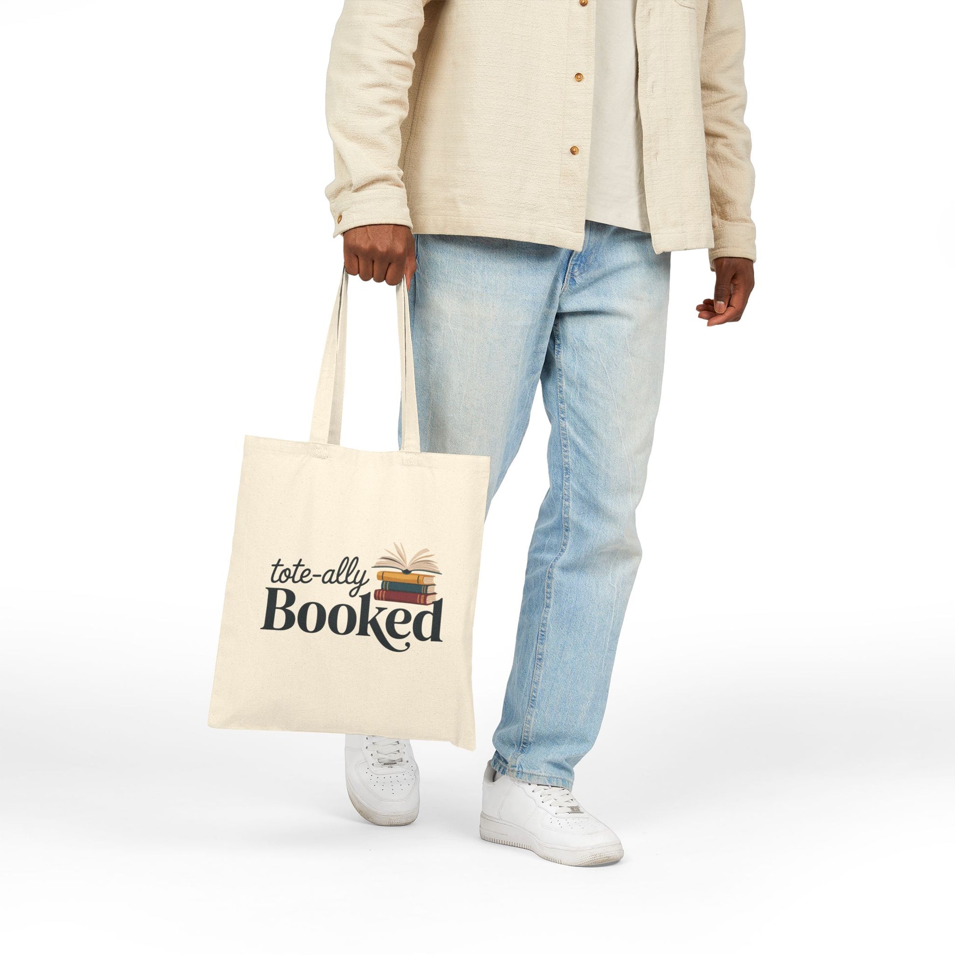 Literary-themed Totally Booked design with book stack on a TEEZOCA tote bag