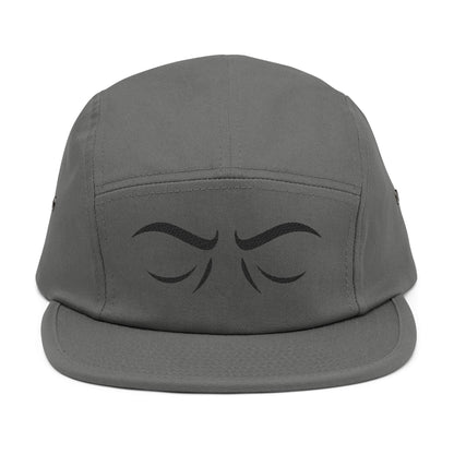 Gray cap with black eye design on a white background. Arched eyebrow expression graphic for embroidery. TEEZOCA