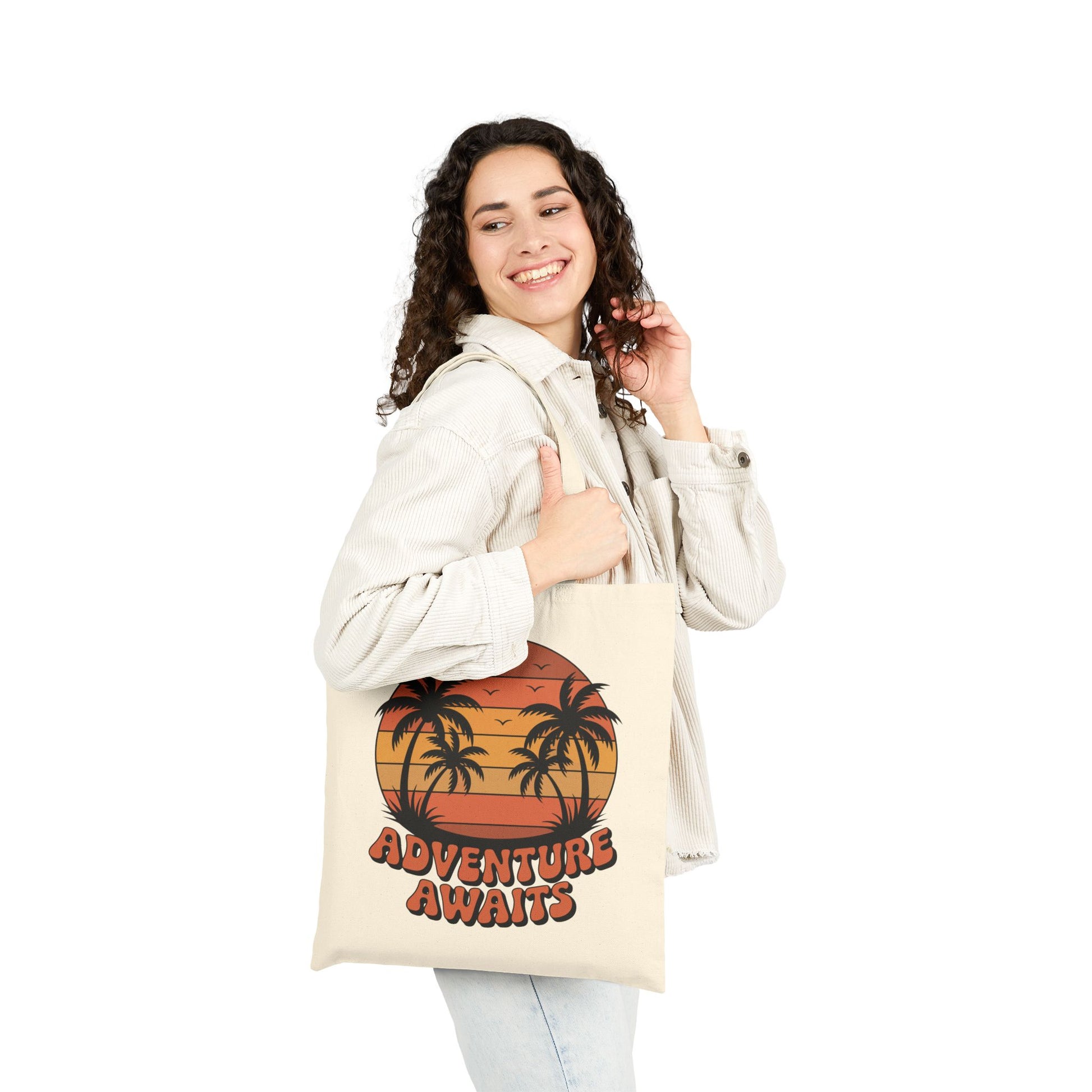Retro sunset and palm trees Adventure Awaits artwork on a TEEZOCA tote bag