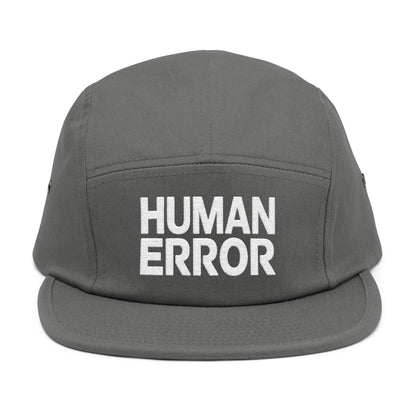 Gray cap with 'HUMAN ERROR' text on a white background. Front view of an embroidered 5-panel cap featuring the bold “HUMAN ERROR” typography in white. TEEZOCA