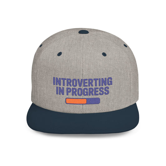 Gray cap with 'Introverting in Progress' text on a white background