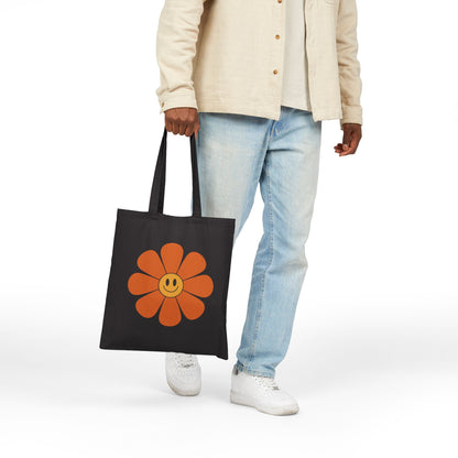 Happy flower graphic with orange petals printed on a TEEZOCA tote bag