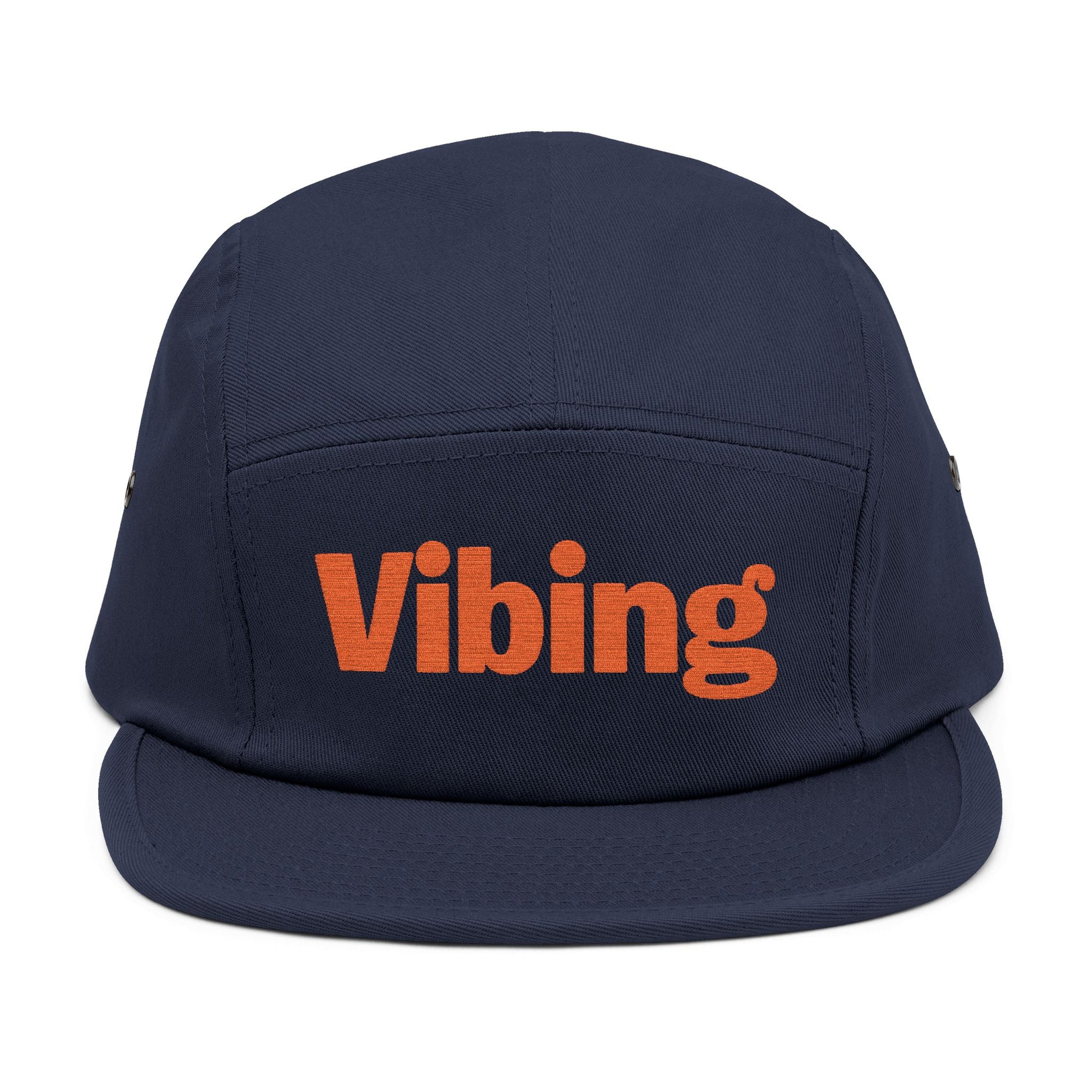 Navy blue cap with 'Vibing' in orange on a white background. Close-up of “Vibing” premium embroidery for streetwear style. TEEZOCA