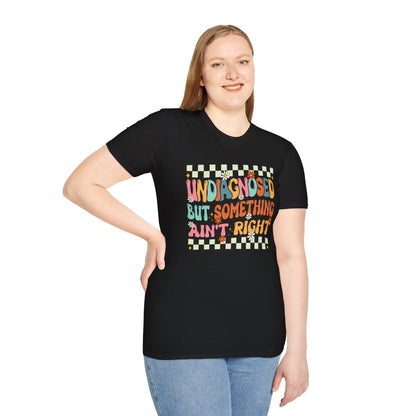 Person wearing a black t-shirt with colorful text design on a white background