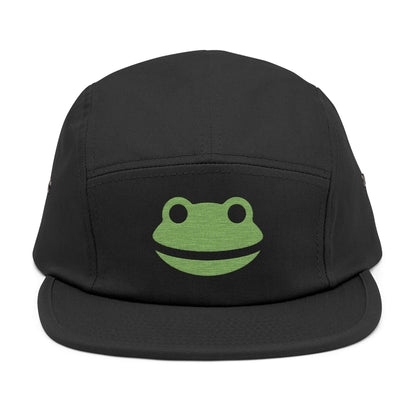 Black cap with a green frog logo on a white background. Minimalist frog face embroidery design with wide smile and round eyes. TEEZOCA