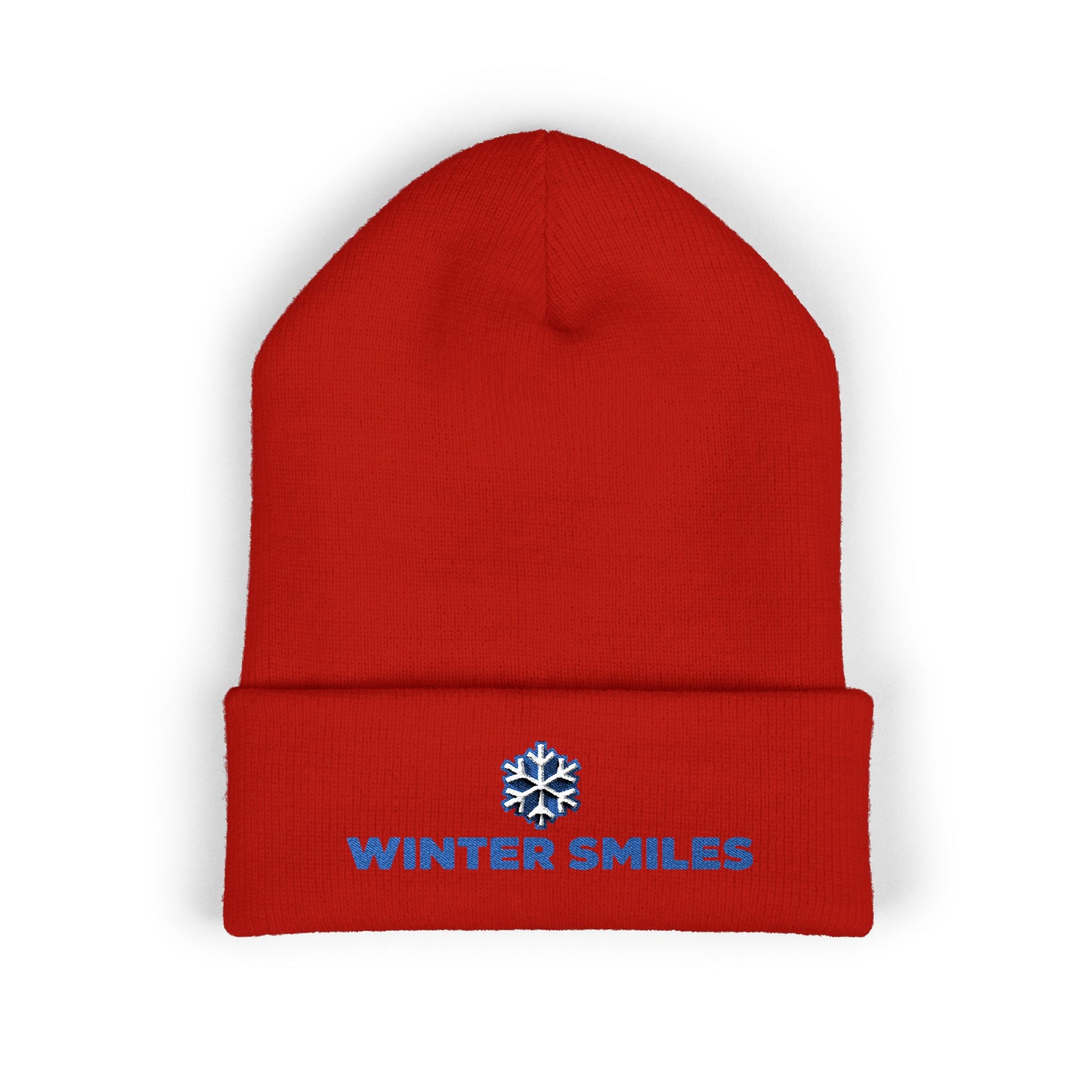 Red beanie with 'Winter Smiles' text and snowflake logo on a white background. Cuffed winter beanie featuring bold “Winter Smiles” lettering