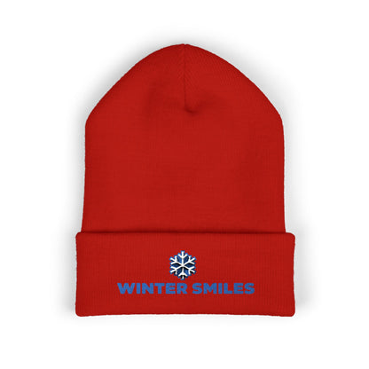 Red beanie with 'Winter Smiles' text and snowflake logo on a white background. Cuffed winter beanie featuring bold “Winter Smiles” lettering