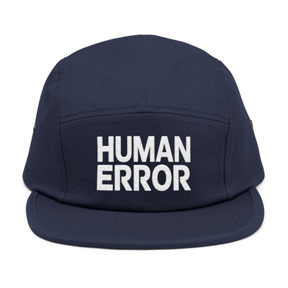 Navy blue cap with 'HUMAN ERROR' text on a white background. Front view of an embroidered 5-panel cap featuring the bold “HUMAN ERROR” typography in white. TEEZOCA