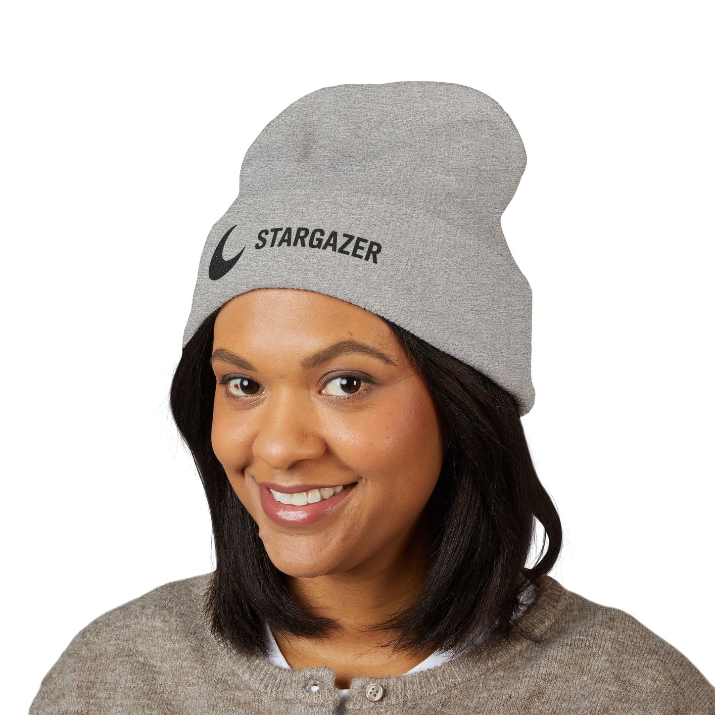 Person wearing a gray 'Stargazer' beanie on a white background