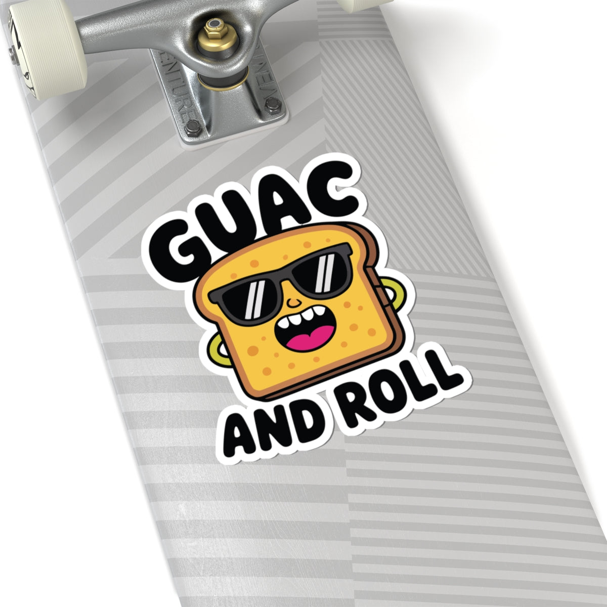 Skateboard with a sticker of a cartoon avocado toast wearing sunglasses and the text 'GUAC AND ROLL'. TEEZOCA