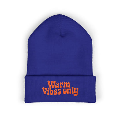 Blue beanie with 'Warm Vibes only' text in orange on a white background. Winter beanie with bold orange embroidered text adding warm, positive energy.
