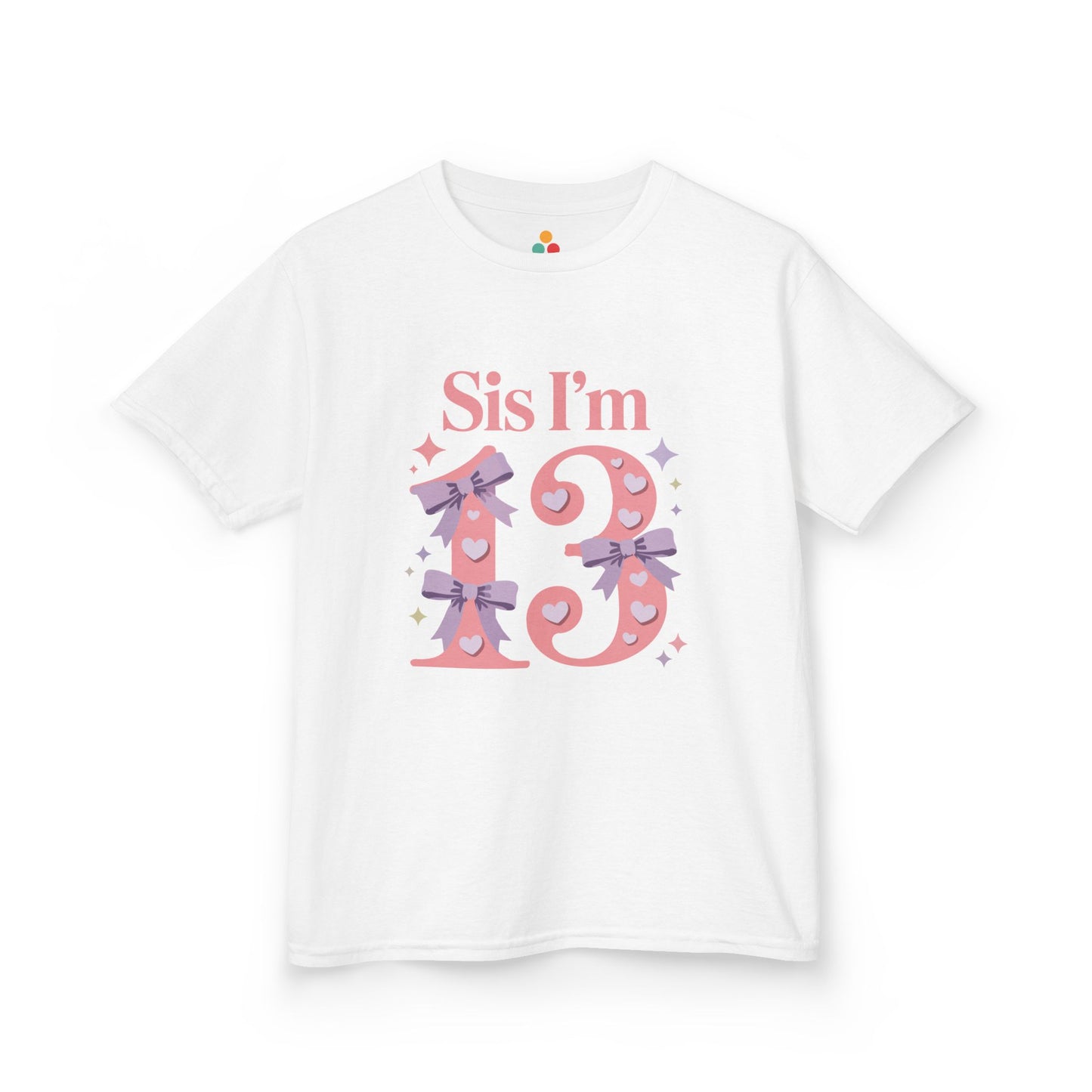 White t‑shirt with pink “Sis I’m 13” design featuring hearts, lilac bows, and sparkles, flat front view.