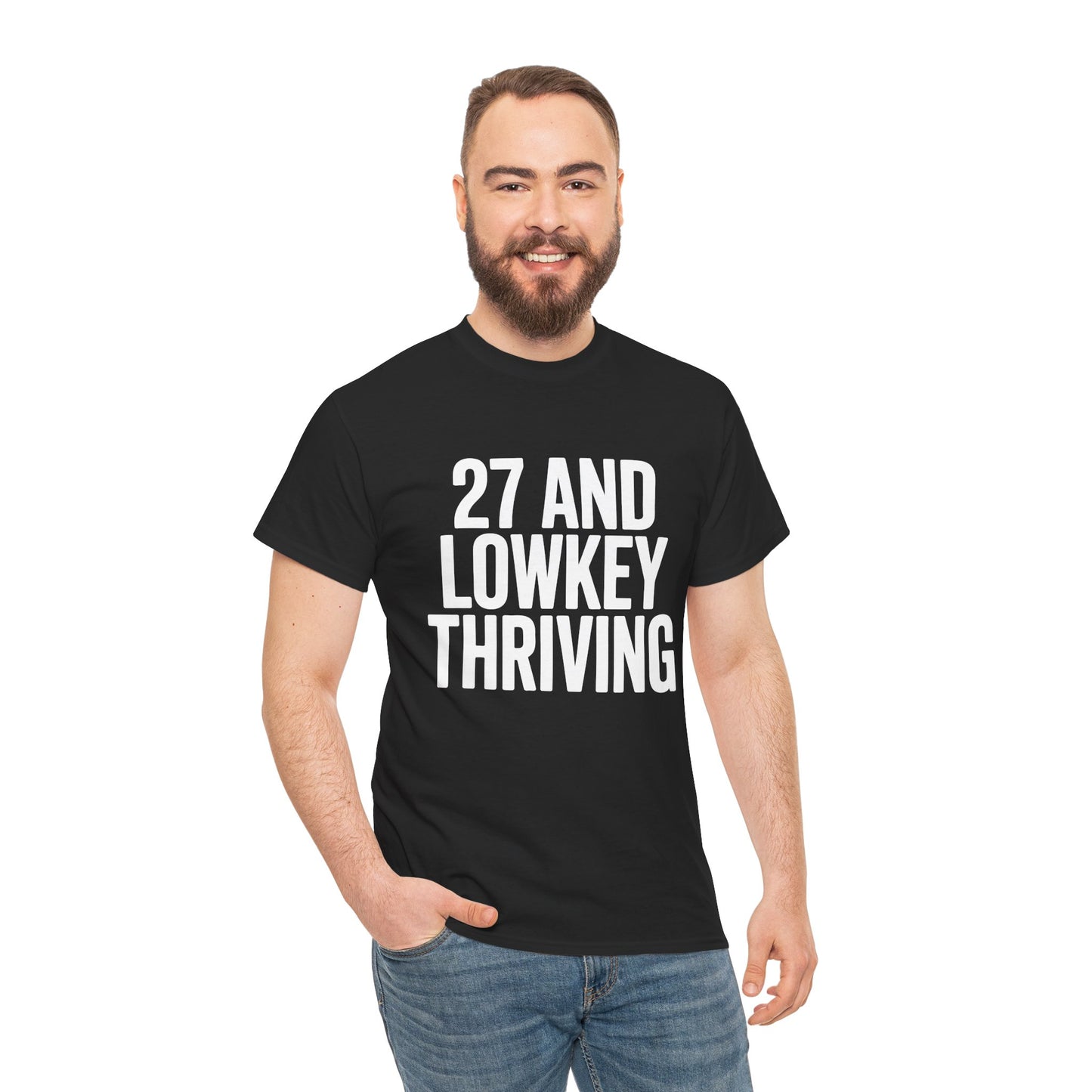Man wearing a black t-shirt with '27 AND LOWKEY THRIVING' text on a white background