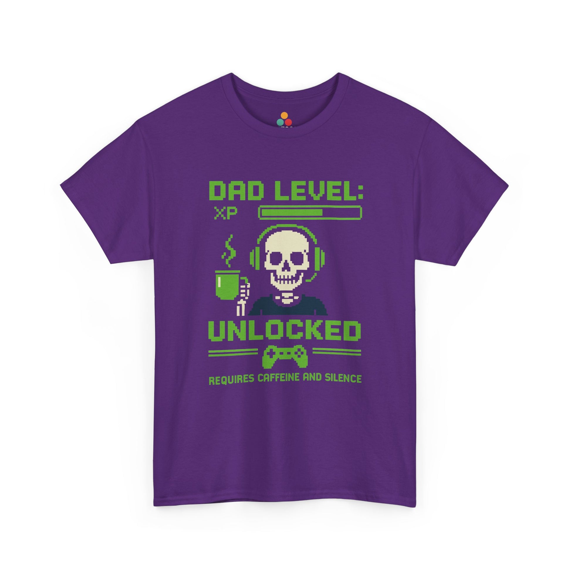 “Purple ‘Dad Level: XP Unlocked’ pixel gamer tee with skull, headset, coffee cup, and controller graphic, flat front.”

