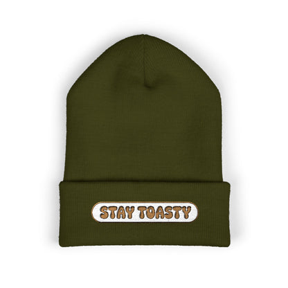 Green beanie with 'Stay Toasty' text on a white background
