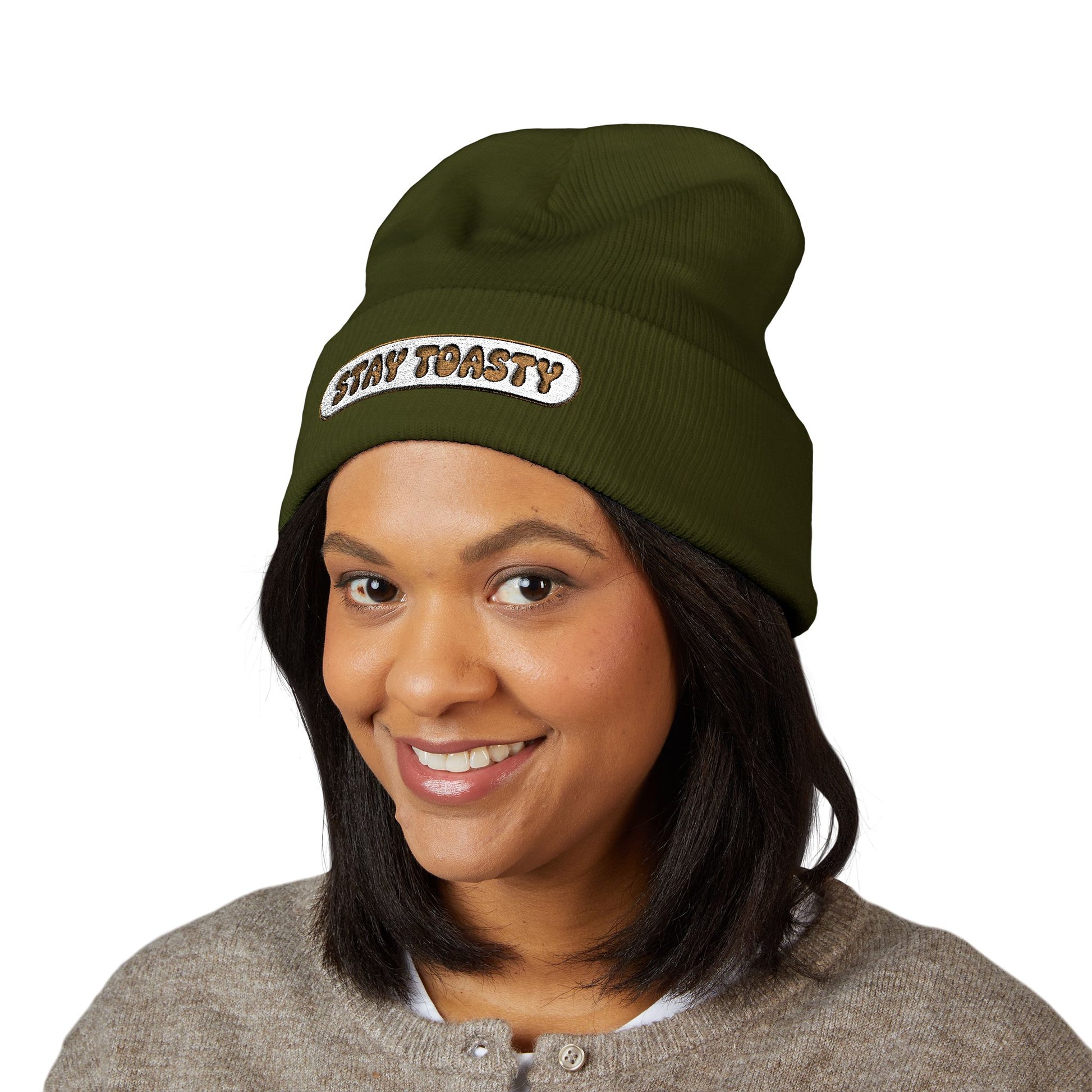 Person wearing a green beanie with 'Stay Toasty' text on a white background