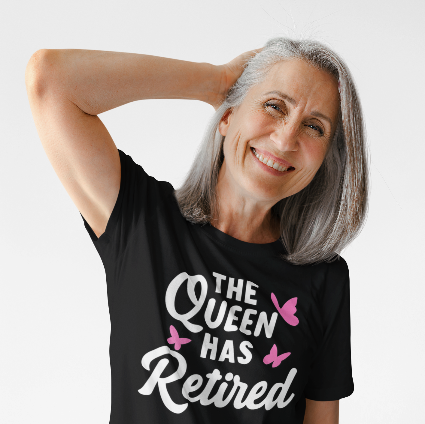 “Smiling older woman wearing a black Teezoca The Queen Has Retired t-shirt, lifestyle mockup, front view.”
